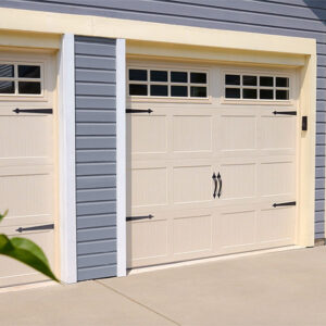 A white garage door with decorative accents on a home.